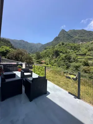 a balcony with a view of a mountain at The Green Valley House in São Vicente
