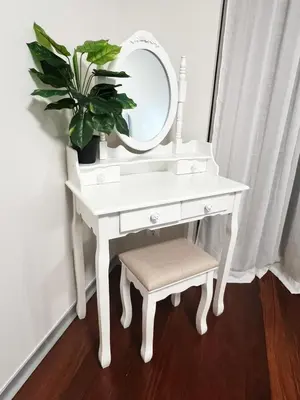 a white dressing table with a mirror and a plant at Funchal Plaza in Funchal