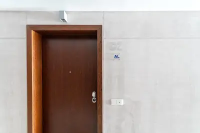 a brown door with a sign on the side of a building at Funchal Plaza in Funchal