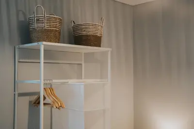 two baskets sitting on top of a white shelf at Pico Apartment's in Câmara de Lobos