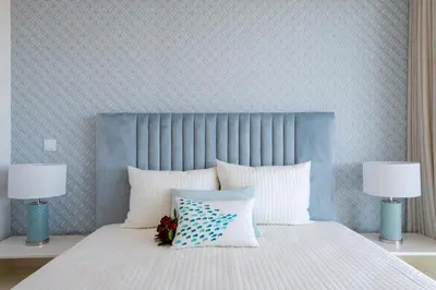 a bed with a blue headboard and white pillows at The King Apartment By Sam Houses in Funchal