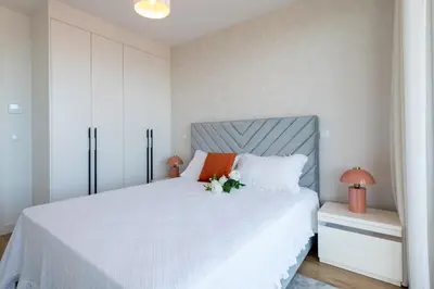 a bedroom with a large white bed with flowers on it at The King Apartment By Sam Houses in Funchal