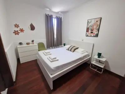 a white bedroom with a bed and a dresser at Bay View House by MTH in Funchal
