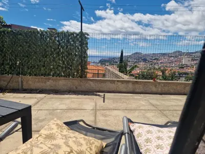 a hot tub on a balcony with an umbrella at Bay View House by MTH in Funchal