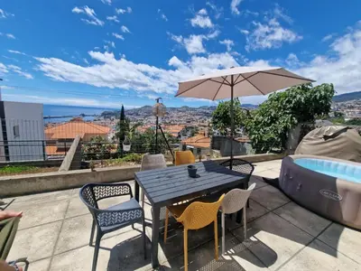 two chairs and a table on a patio at Bay View House by MTH in Funchal