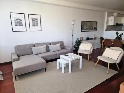 a living room with a couch and a table and chairs at Bay View House by MTH in Funchal