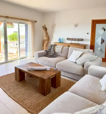 a bedroom with a large bed with white sheets and pillows at Exklusive Luxusvilla - Meerblick - beheizter Pool in Mato Porcas