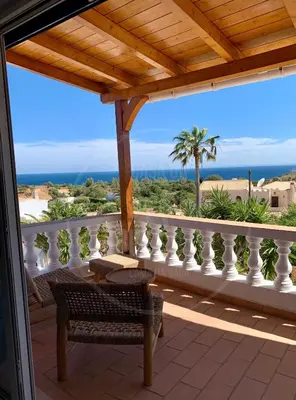 a bedroom with a bed and a mirror and a chair at Exklusive Luxusvilla - Meerblick - beheizter Pool in Mato Porcas