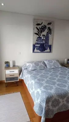 a bedroom with a bed and a night stand at Casa Monte Ponta do Sol SeaViews in Ponta do Sol