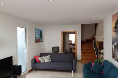 a living room with a couch and a staircase at Casa Monte Ponta do Sol SeaViews in Ponta do Sol