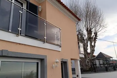 a window on a building with a tree in the background at Casa Monte Ponta do Sol SeaViews in Ponta do Sol