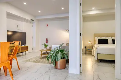 a bedroom with a bed and a table and a tv at Beco Santa Emilia 4O, a Home in Madeira in Funchal