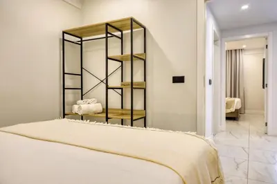 a room with a bed and a shelf with towels at Beco Santa Emilia 4O, a Home in Madeira in Funchal
