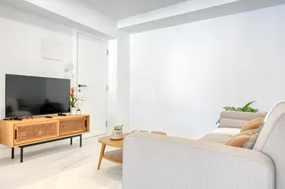 a living room with a couch and a tv at Beco Santa Emilia 4O, a Home in Madeira in Funchal
