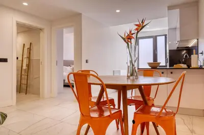 a kitchen and dining room with a wooden table and chairs at Beco Santa Emilia 4O, a Home in Madeira in Funchal