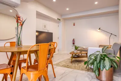 a living room with a table and chairs at Beco Santa Emilia 4O, a Home in Madeira in Funchal