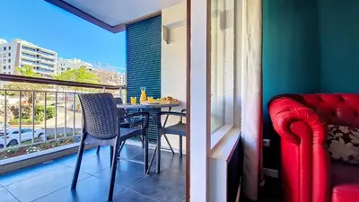 a balcony with a table and chairs and a window at Caracas Escape by LovelyStay in Funchal