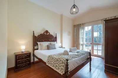 a bedroom with a large bed and a window at Vivenda Alves by GALMI in Gaula