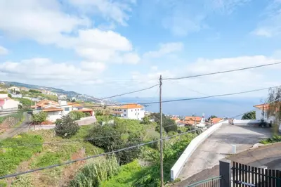 a view of a street with houses and the ocean at Vivenda Alves by GALMI in Gaula