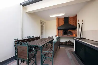 a kitchen with a wooden table and an oven at Vivenda Alves by GALMI in Gaula