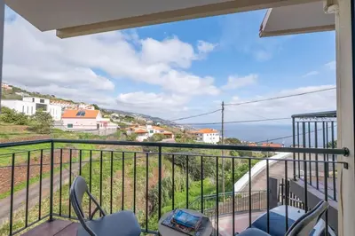 a balcony with chairs and a view of a city at Vivenda Alves by GALMI in Gaula