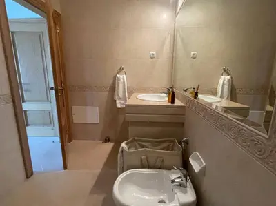 a bathroom with a sink and a toilet and a mirror at Casa com Vista in Lagos