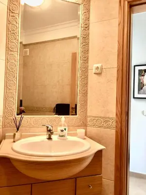 a bathroom with a sink and a mirror at Casa com Vista in Lagos