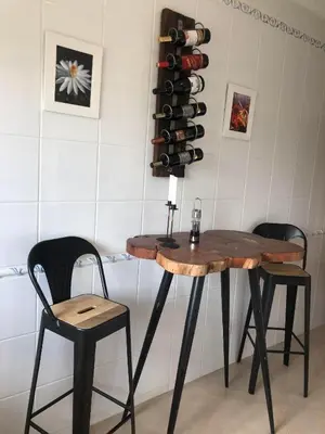 a table with two chairs and a wine rack at Casa com Vista in Lagos