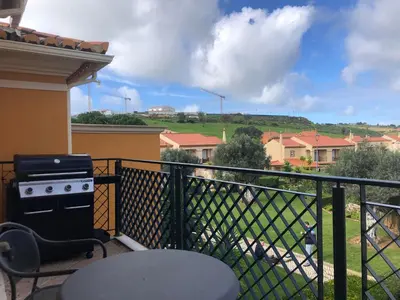 a balcony with a stove and a view of a field at Casa com Vista in Lagos