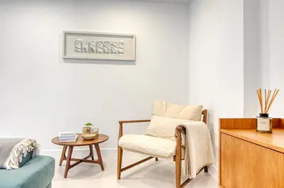 a living room with a chair and a table at Beco Santa Emilia 4P, a Home in Madeira in Funchal