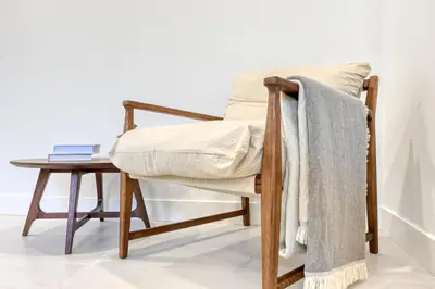 a chair with a blanket on it next to a table at Beco Santa Emilia 4P, a Home in Madeira in Funchal