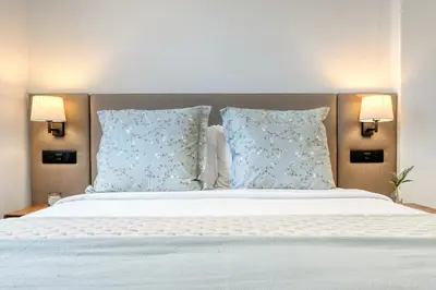 a bedroom with a large bed with blue pillows at Beco Santa Emilia 4P, a Home in Madeira in Funchal
