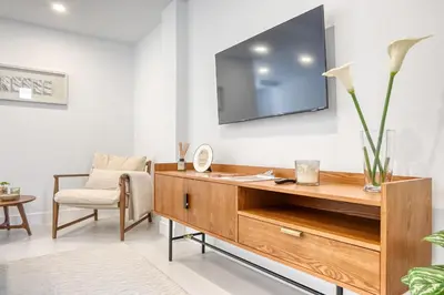 a living room with a tv on a wall at Beco Santa Emilia 4P, a Home in Madeira in Funchal