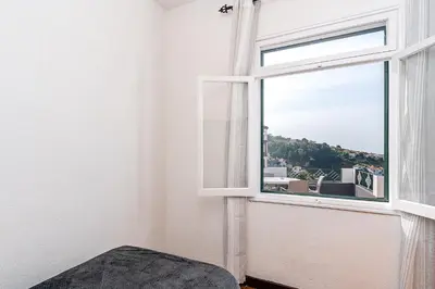 a room with a window with a view of a city at Achada House - Traditional House in Calheta
