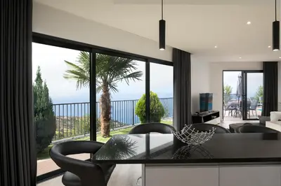 a living room with a view of the ocean at Villa Panorâmica III in Arco da Calheta