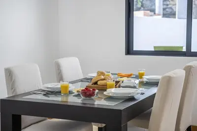 a dining room table with a meal on it at Til Home by Homie in Funchal