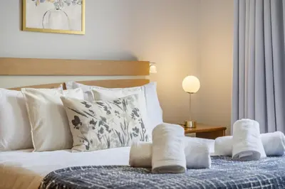 a bedroom with a bed with white towels on it at Til Home by Homie in Funchal