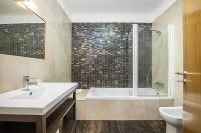 a bathroom with a tub and a sink and a shower at Til Home by Homie in Funchal