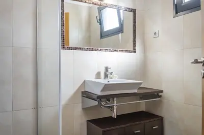 a bathroom with a sink and a mirror at Til Home by Homie in Funchal