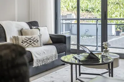 a living room with a couch and a table with a laptop at Til Home by Homie in Funchal
