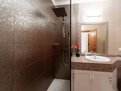 a bathroom with a shower and a sink and a mirror at GuestReady - Oasis Getaway in Madeira in Caniço
