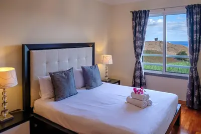a bedroom with a large white bed with a window at GuestReady - Oasis Getaway in Madeira in Caniço