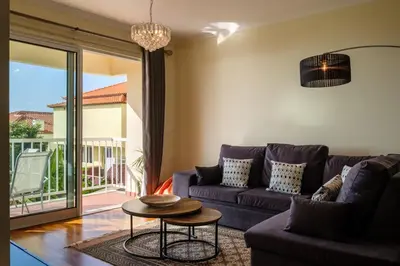 a living room with a purple couch and a table at GuestReady - Oasis Getaway in Madeira in Caniço