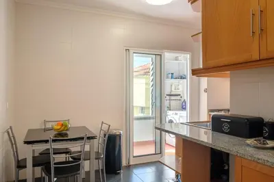 a kitchen with a table with chairs and a counter top at GuestReady - Oasis Getaway in Madeira in Caniço