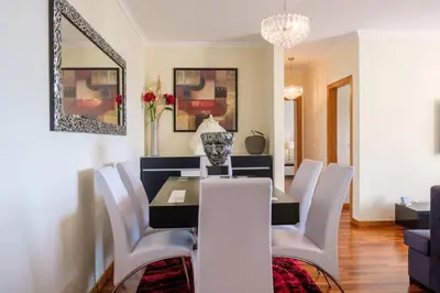 a dining room with a table and white chairs at GuestReady - Oasis Getaway in Madeira in Caniço