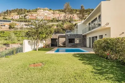 a house with a yard with a swimming pool at THE OLD CHAPEL HOUSE in Funchal
