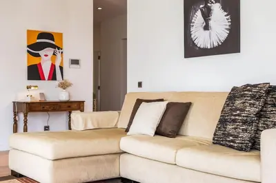 a living room with a couch and a painting at THE OLD CHAPEL HOUSE in Funchal
