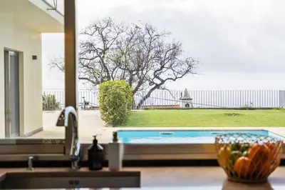 a kitchen with a sink and a view of a yard at THE OLD CHAPEL HOUSE in Funchal