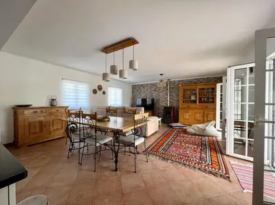 a kitchen and dining room with a table and chairs at Canto do Vale in Aljezur