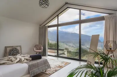 a living room with a couch and a large window at Blue Horizon Luxury Villa in Senhora do Rosário